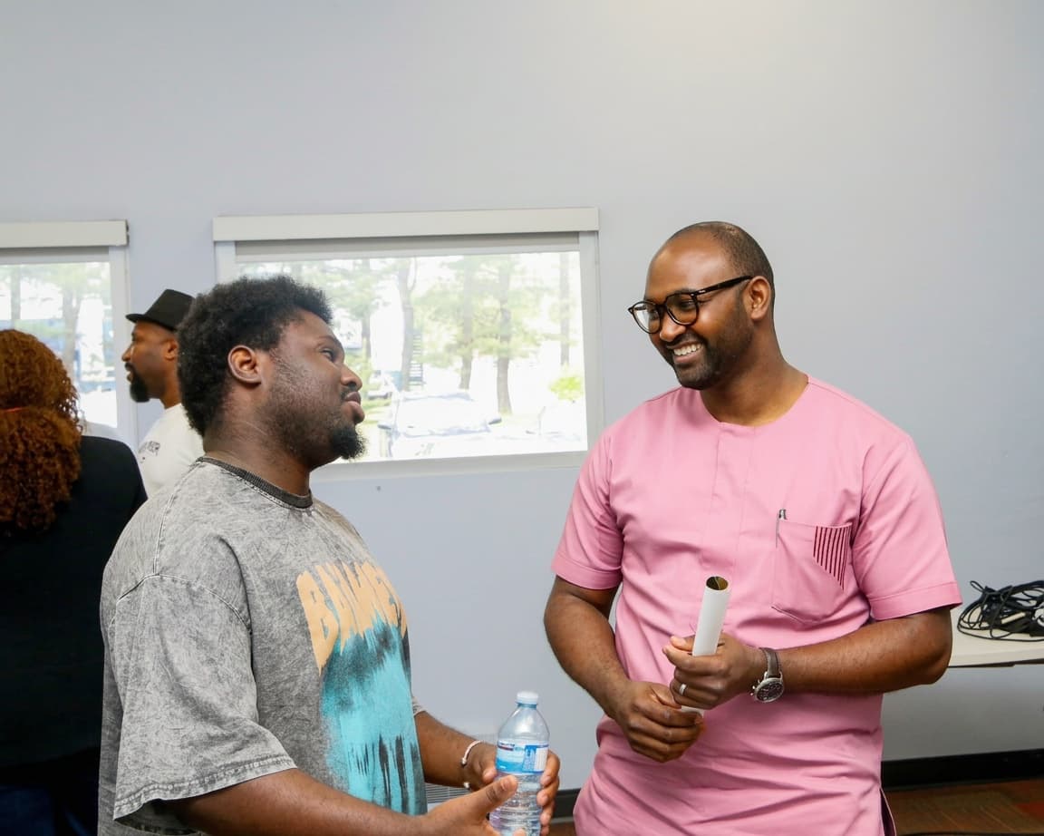 Two participants chat and smile during a COPAJE AF/CA networking event in Moncton